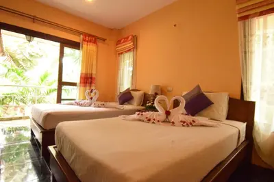 a room with three beds with bows on them at Aonang Lake Side in Ao Nang Beach