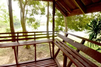a porch with a bench and a view of a river at Aonang Lake Side in Ao Nang Beach