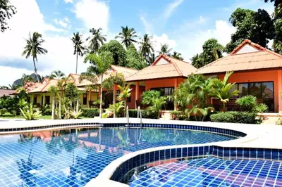 a large swimming pool in front of a house at Sawaddee Aonang Resort in Ao Nang Beach