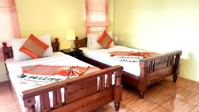 two beds sitting next to each other in a room at Sawaddee Aonang Resort in Ao Nang Beach
