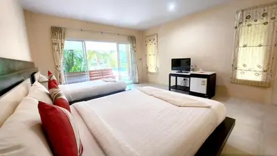 a hotel room with two beds and a television at Sawaddee Aonang Resort in Ao Nang Beach