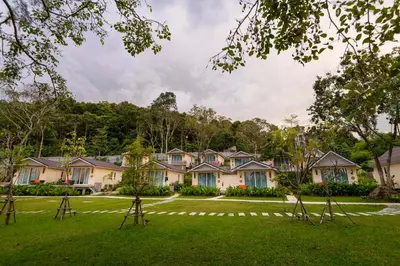 a row of houses on a green lawn at Krabi Home Resort in Tab Kaek Beach