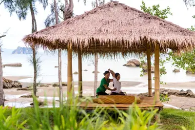 a couple sitting in a hut on the beach at Krabi Home Resort in Tab Kaek Beach