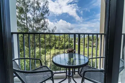 a table and chairs on a balcony with a view at ZcapeX2 in Bang Tao Beach
