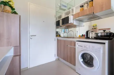 a kitchen with a washer and a washing machine at ZcapeX2 in Bang Tao Beach