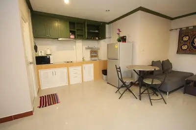 a small kitchen with a table and a refrigerator at KD Residence in Bang Tao Beach