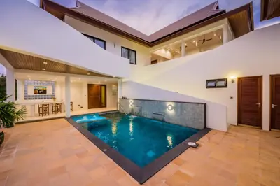 a swimming pool in the middle of a house at Penthouse Savoye in Ao Nang Beach