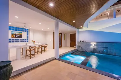 an indoor pool with a bar and a kitchen and a house at Penthouse Savoye in Ao Nang Beach