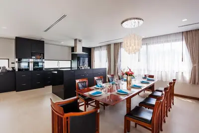 a kitchen and dining room with a table and chairs at Penthouse Savoye in Ao Nang Beach