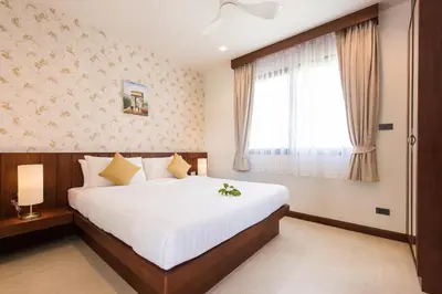 a bedroom with a large bed and a window at Penthouse Savoye in Ao Nang Beach