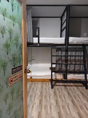 a room with two bunk beds and a door at Backpack Hostel Kohyaoyai in Ko Yao Yai