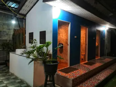 a room with a blue wall and some plants at Backpack Hostel Kohyaoyai in Ko Yao Yai
