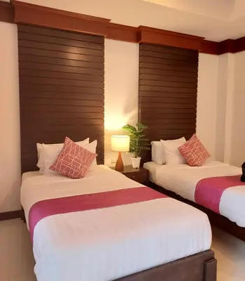two beds in a hotel room with two beds at Aromdee at Naithon Beach in Nai Thon Beach