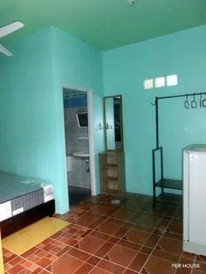 a room with a blue wall and a bathroom with a shower at Pek House in Phuket Town