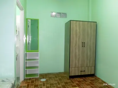 a bathroom with a wooden cabinet and a mirror at Pek House in Phuket Town