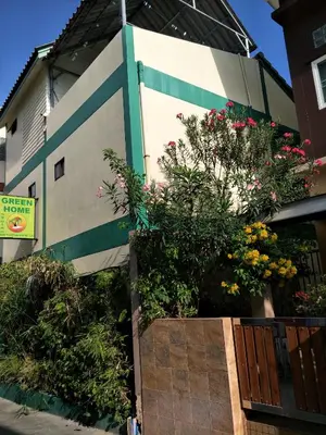 a building with flowers on the side of it at Phuket Green Home in Karon Beach