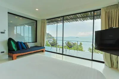 a bedroom with a bed and a large window at 8IK88 Resort, Phuket - SHA Extra Plus in Por Bay