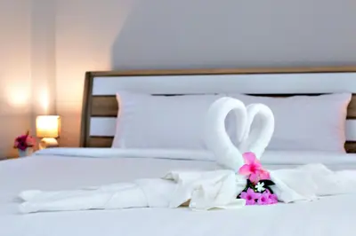 a bed with two swans made out of towels at Maikhao Beach Residence in Mai Khao Beach