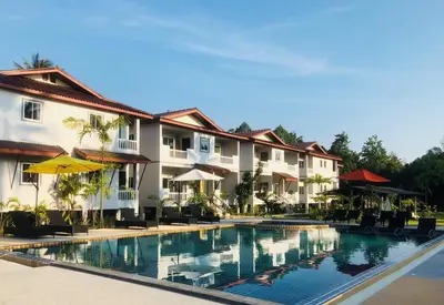 a swimming pool in front of a hotel at Maikhao Beach Residence in Mai Khao Beach