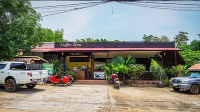 a white truck parked in front of a coffee shop at Baansuan Amaleena in Ko Yao Noi