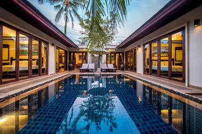 a swimming pool in a villa with a resort at Pai Tan Villas - SHA Extra Plus in Bang Tao Beach