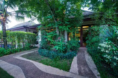 a walkway in front of a house with plants at Pai Tan Villas - SHA Extra Plus in Bang Tao Beach