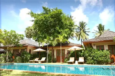 a villa with a swimming pool and a resort at Pai Tan Villas - SHA Extra Plus in Bang Tao Beach