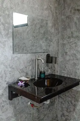 a bathroom with a sink and a mirror at Sunrise House in Ko Yao Noi