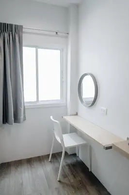 a white room with a desk and a mirror at Wynn House in Karon Beach