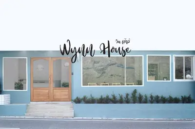 a blue building with a sign that reads your house at Wynn House in Karon Beach