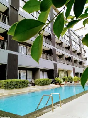 a swimming pool in front of a building at The Lantern Resorts Patong in Patong Beach
