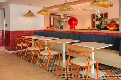 a row of tables and chairs in a restaurant at The Lantern Resorts Patong in Patong Beach
