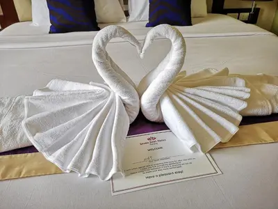 two swans making a heart on a bed at Seven Seas Hotel Patong Beach in Patong Beach