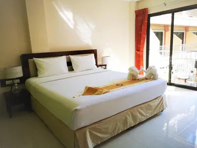 a bedroom with a bed with two stuffed animals on it at Seven Seas Hotel Patong Beach in Patong Beach
