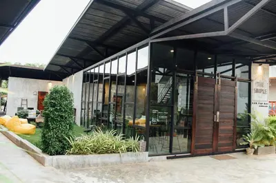 a building with glass doors and plants in front of it at The Simple Koh Yao Noi in Ko Yao Noi