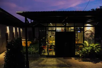 a building with a patio with a table and chairs at The Simple Koh Yao Noi in Ko Yao Noi