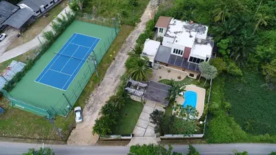 an overhead view of a tennis court in front of a house at Villa Kanwara in Ao Nang Beach