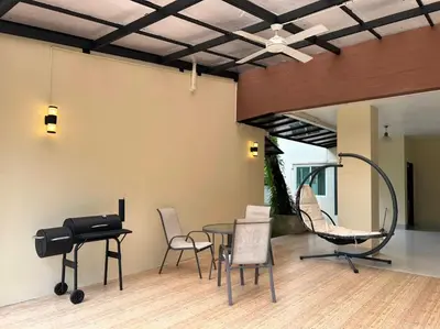 a room with a table and chairs and a piano at Villa Kanwara in Ao Nang Beach