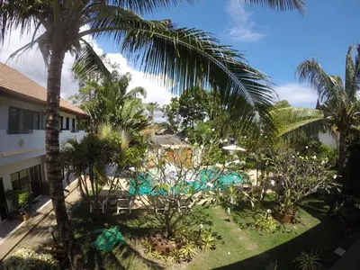 an aerial view of a resort with palm trees and a pool at Babylon Pool Villas in Nai Harn Beach