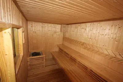 a wooden interior of a sauna with wood paneling at Babylon Pool Villas in Nai Harn Beach