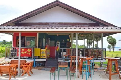 a restaurant with tables and chairs under a pavilion at Anissa Resort Koh Yao Yai in Ko Yao Yai