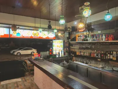 a bar in a restaurant with a car in the background at Sea Beach Paradise in Patong Beach