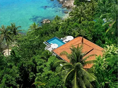 an aerial view of a house with a swimming pool at Trisara Villas & Residences Phuket in Nai Thon Beach