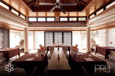 a restaurant with tables and chairs in a room at Trisara Villas & Residences Phuket in Nai Thon Beach