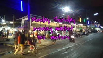 a group of people walking down a street at night at Soi Bang thao 2 Aircon Studio in Bang Tao Beach