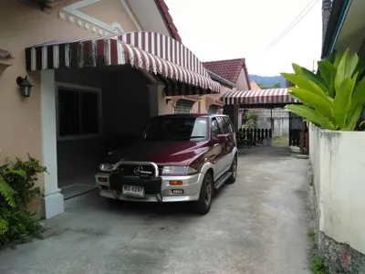 a car parked in front of a house at Soi Bang thao 2 Aircon Studio in Bang Tao Beach