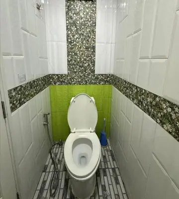 a small bathroom with a white toilet in a room at Soi Bang thao 2 Aircon Studio in Bang Tao Beach