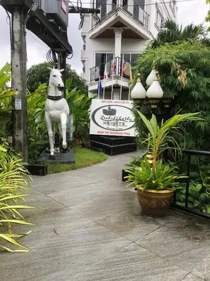 a statue of a horse in front of a house at Orchid Kathu Heights Service Apartments in Kathu