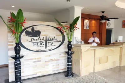 a man standing at the counter of a restaurant at Orchid Kathu Heights Service Apartments in Kathu