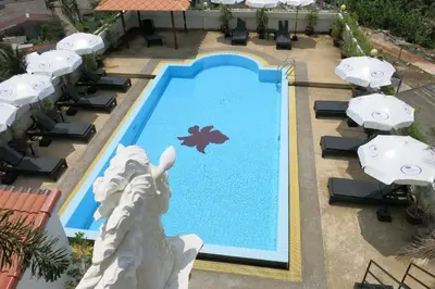an overhead view of a swimming pool with umbrellas at Orchid Kathu Heights Service Apartments in Kathu